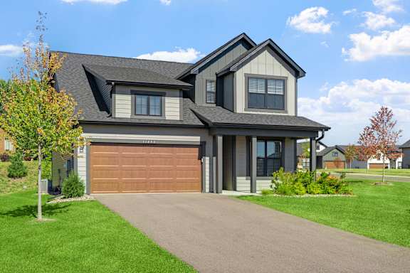 A modern house with a brown garage door.