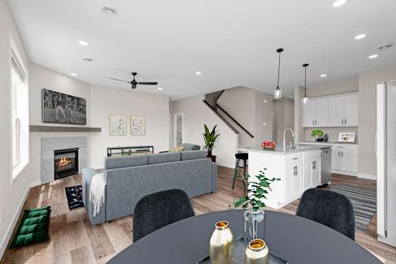 A modern living room with a grey sofa and a fireplace.