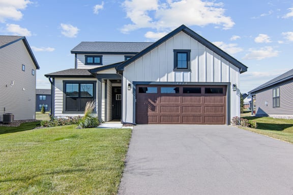 a house with a brown garage door and a driveway