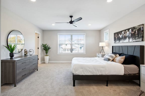 a bedroom with a large bed and a dresser