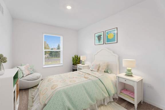 A bedroom with a bed, nightstand, and a window with blinds.