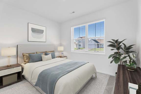 A bedroom with a large bed and a window overlooking a street.