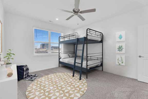 A room with a bunk bed and a ceiling fan.