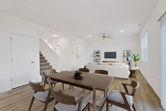 A dining room with a wooden table and chairs.