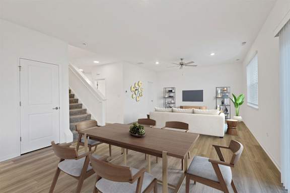 A dining room with a wooden table and chairs.