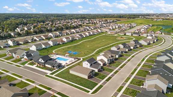 A suburban neighborhood with houses and a swimming pool.