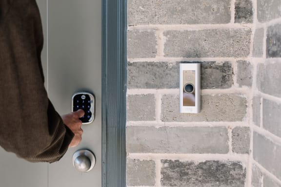 a person is unlocking a door with a remote control
