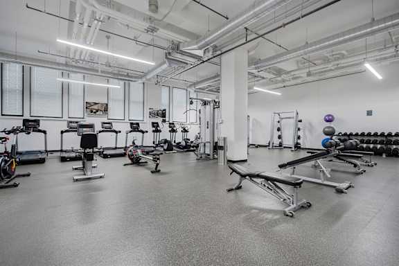 A gym with a variety of exercise equipment.