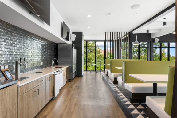 a kitchen and dining area with wood floors and a black and white checkered rug