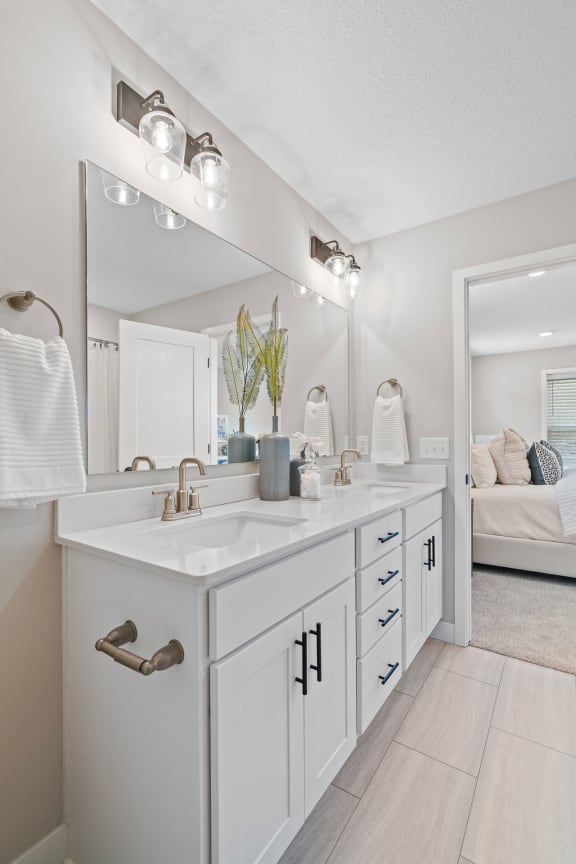 a white bathroom with a sink and a mirror
