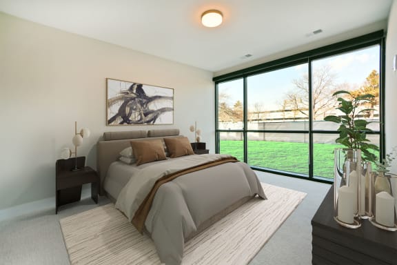 a bedroom with a bed and a large window