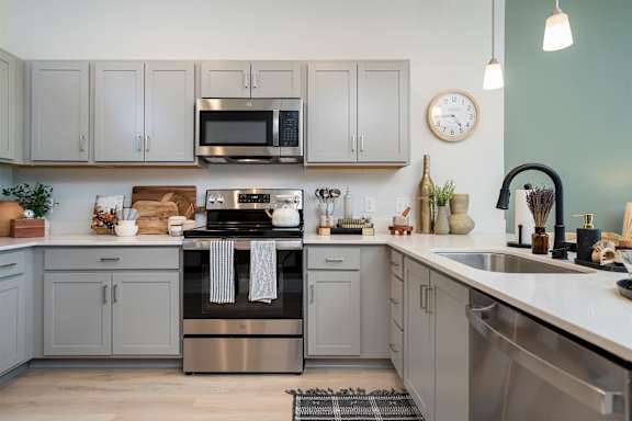 A kitchen with a stove, oven, and microwave.