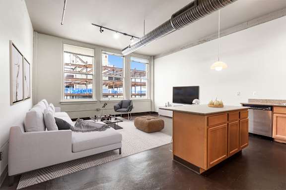 an open living room with a couch and a tv