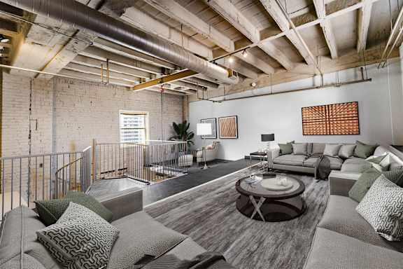 a living room with couches and a table in a loft