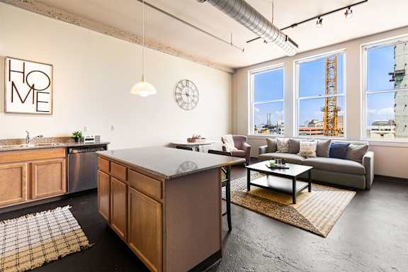 an open living room with a kitchen and a view of the city