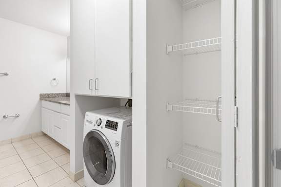 a white laundry room with a washer and dryer in it