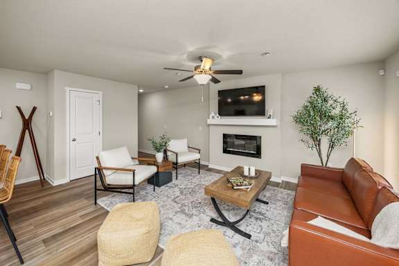 A living room with a fireplace and a television.