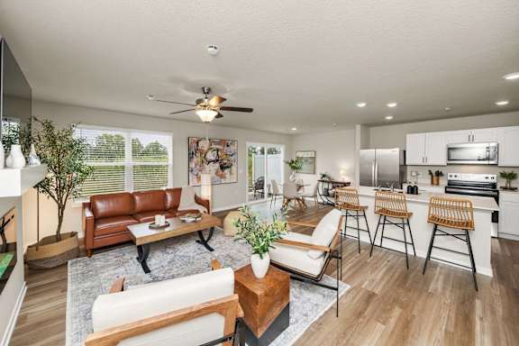 A modern living room with a brown leather couch and a wooden coffee table.