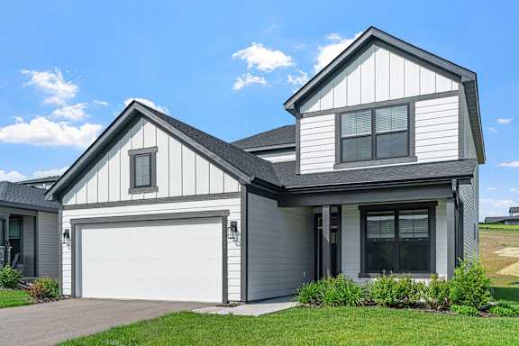 A two-story house with a garage on the ground floor.