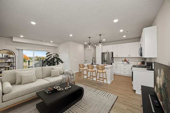 A modern living room with a white sofa and a black coffee table.