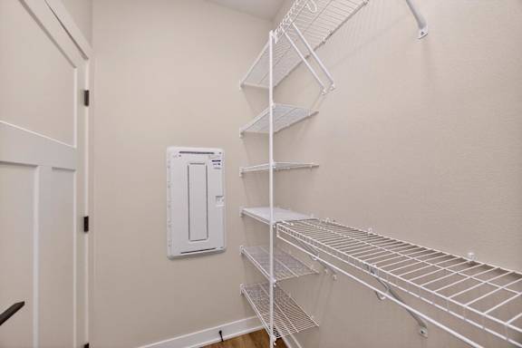 A white metal shelving unit in a room with a white door.