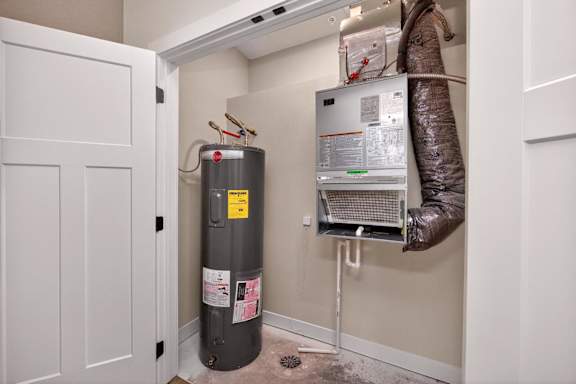 A room with a water heater and a boiler.