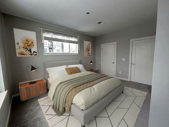 A bedroom with a bed, nightstand, and two pictures on the wall.