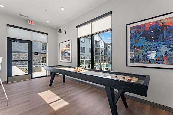 A room with a table and a painting on the wall.