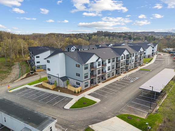 A large building with a parking lot in front of it.