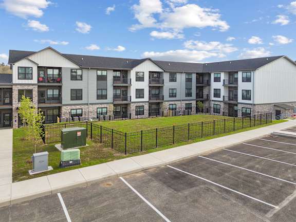 A large building with a parking lot in front of it.