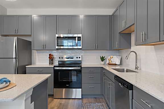 A modern kitchen with a stainless steel oven and microwave.