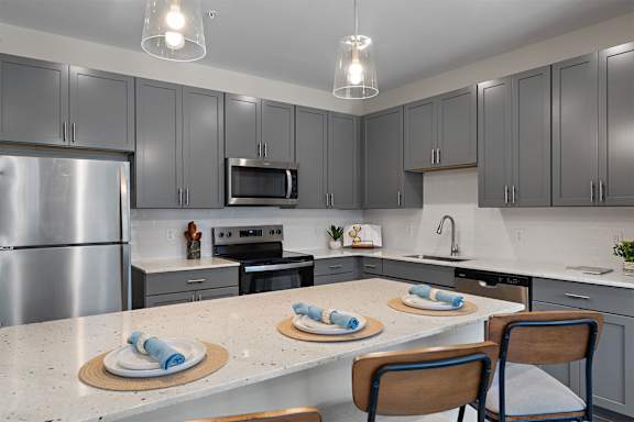 A kitchen with a table set for two.