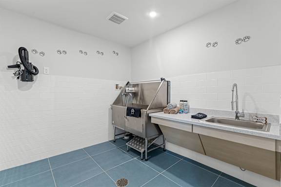 A modern bathroom with a sink, mirror, and shower.
