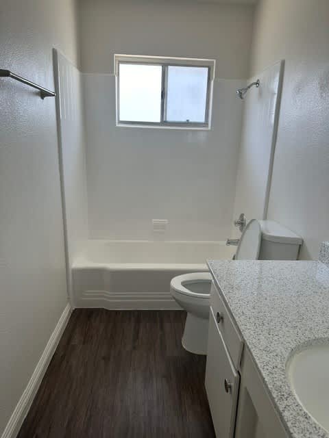 A small bathroom with a toilet, sink, and bathtub.