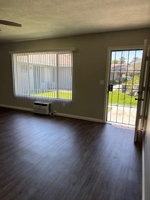 an empty living room with a door and a window