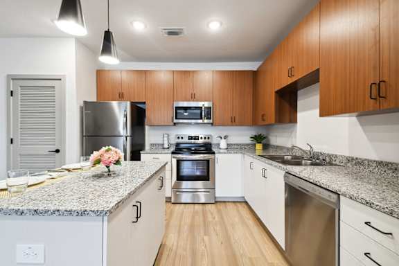 a modern kitchen with granite counter tops and stainless steel appliances