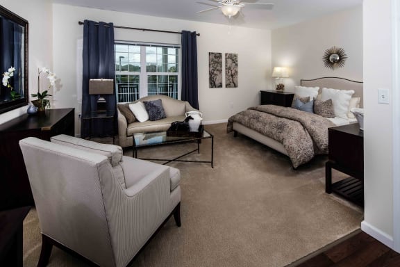 a bedroom with a bed and a chair in a room at Arbor Hills, Lakeland, 33805