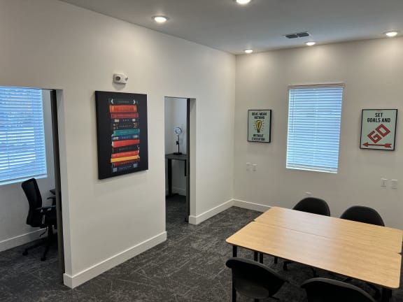 a conference room with a table and chairs and a poster on the wall at Gibson Oaks, Florida