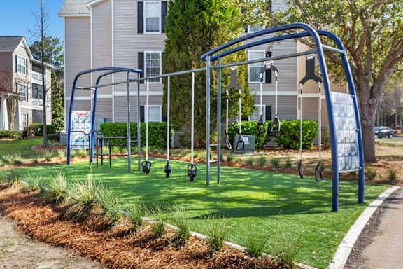 A playground with a swing set and a blue frame.
