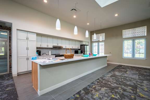 A kitchen with a large island and a skylight.
