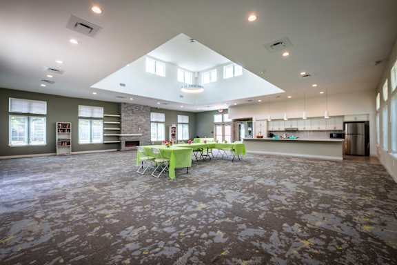 A large room with tables and chairs set up for an event.