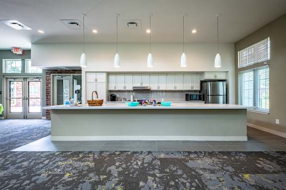 A reception area with a counter and chairs.