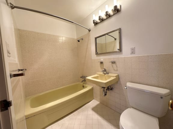 a bathroom with a toilet sink and bathtub