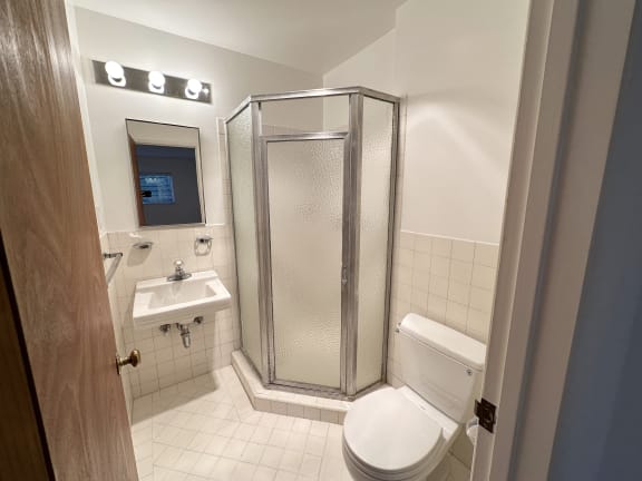 a bathroom with a toilet sink and shower