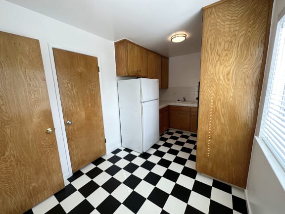 a kitchen with a black and white checkered floor