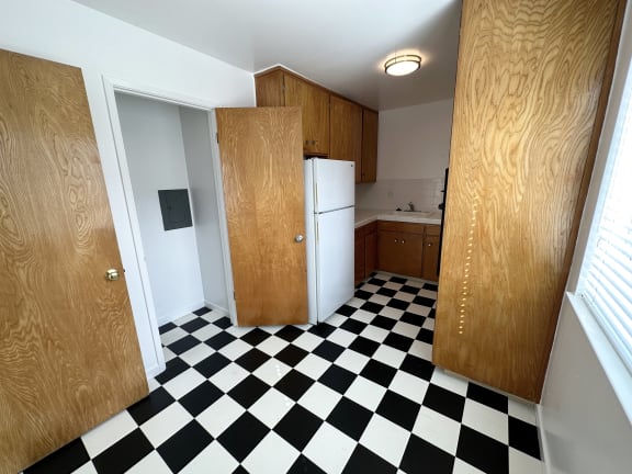 a kitchen with a black and white checkered floor