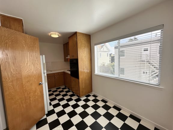 a small kitchen with a checkered floor