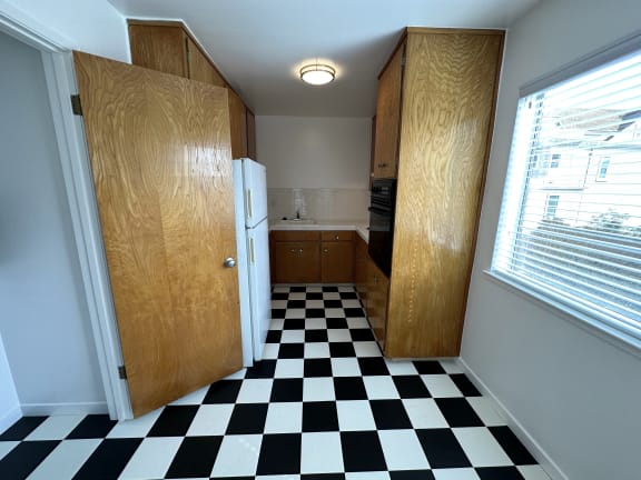 a small kitchen with a checkered floor