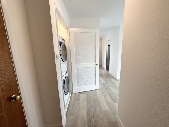 a bedroom with a medium sized closet and a washer and dryer