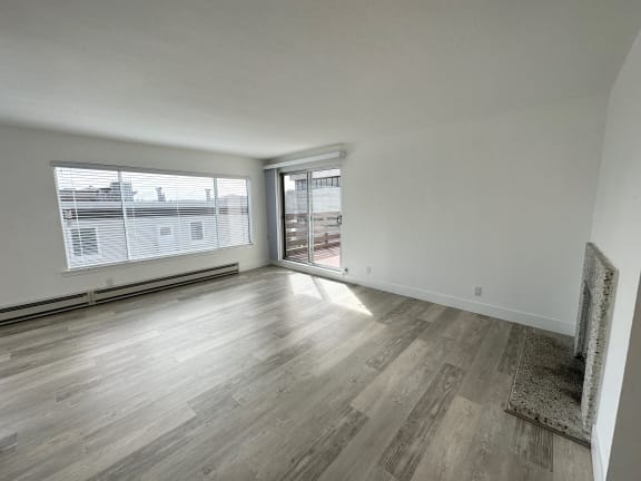 a bedroom with hardwood floors and white walls